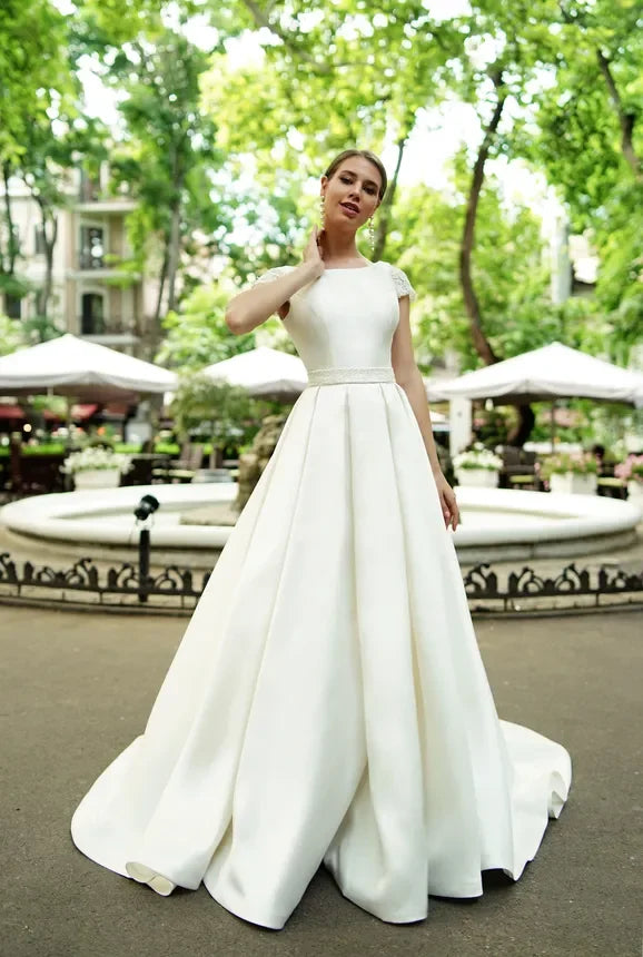 Simple Satin A-Line Wedding Dress Jewel Neck Short Capped Sleeves Backless with Ruched Sash Sweep Train Modern Beach Style